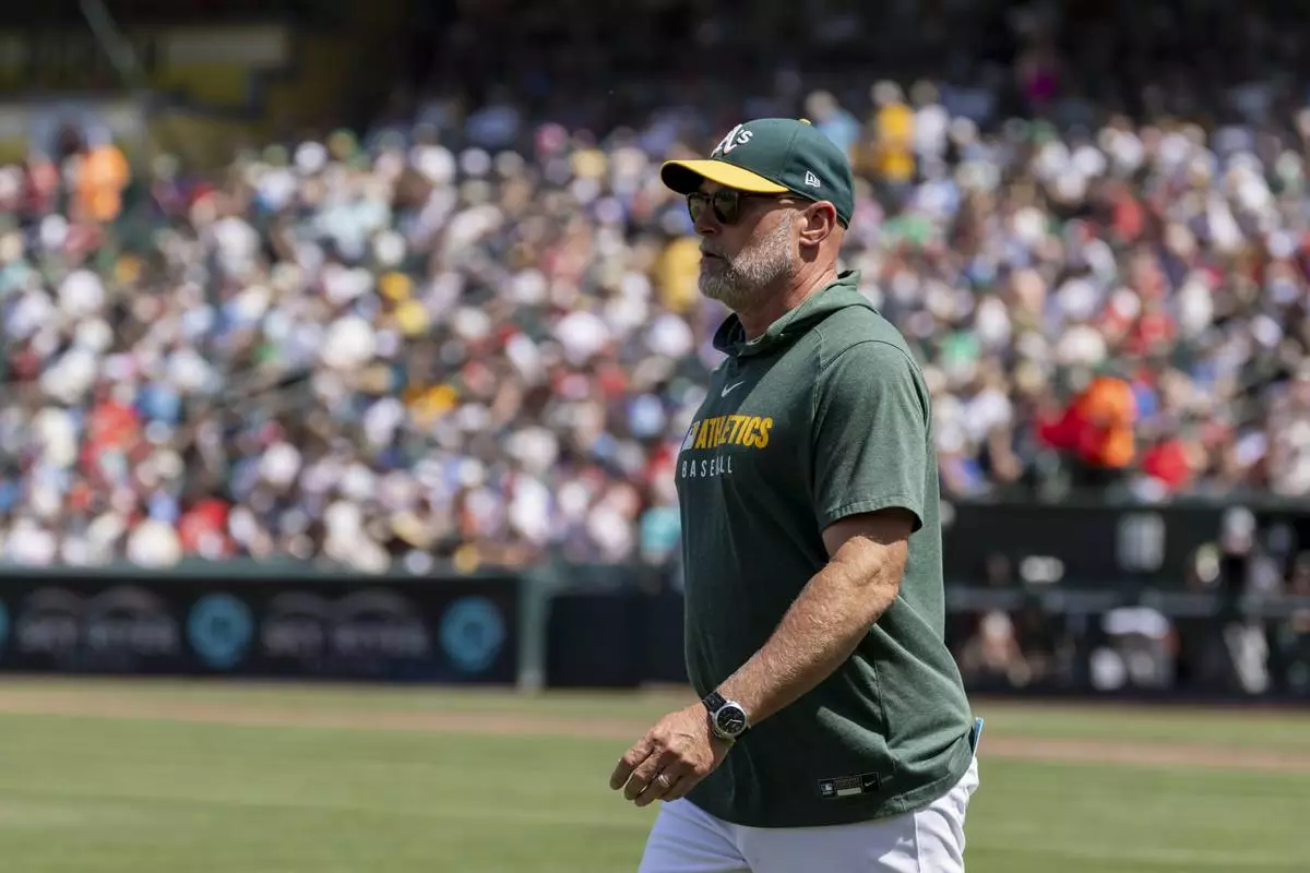 Athletics manager Mark Kotsay leaves the field after being ejected during the seventh inning of a baseball game against the Philadelphia Phillies, Sunday, May 25, 2025, in West Sacramento, Calif. (AP Photo/Sara Nevis)