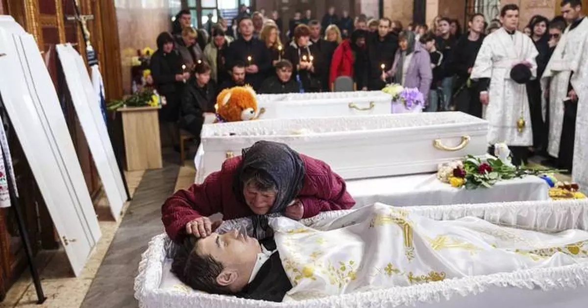 AP PHOTOS: 3 Ukrainian siblings buried after Russian missile strike