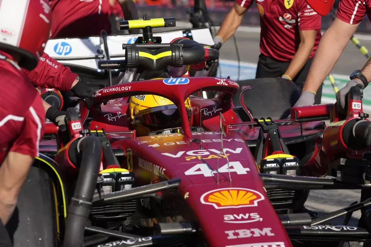 Ferrari driver Lewis Hamilton of Britain gets pushed back into his garage during the second free practice at the Enzo and Dino Ferrari racetrack, ahead the Italy's Emilia Romagna Formula One Grand Prix, in Imola, Italy, Friday, May 16, 2025. (AP Photo/Luca Bruno)