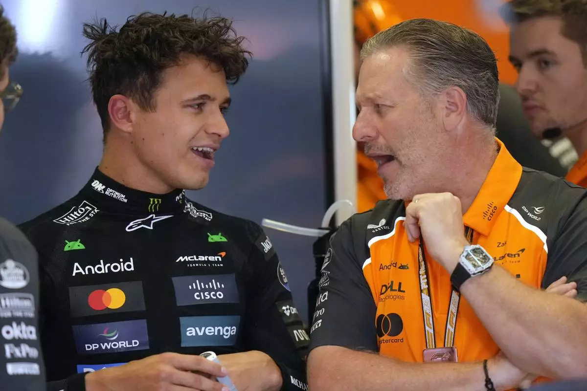 McLaren driver Lando Norris of Britain, left, talks to Zak Brown, McLaren chief, in his garage after the second free practice at the Enzo and Dino Ferrari racetrack, ahead the Italy's Emilia Romagna Formula One Grand Prix, in Imola, Italy, Friday, May 16, 2025. (AP Photo/Luca Bruno)