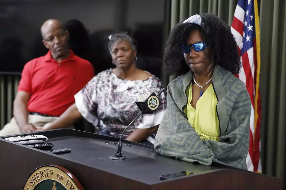 Tiffany Slaton, a hiker found in the High Sierra after going missing for three weeks, speaks during a press conference as her parents Bobby and Fredrina look on, Friday, May 16, 2025 in Fresno, Calif. (AP Photo/Gary Kazanjian)