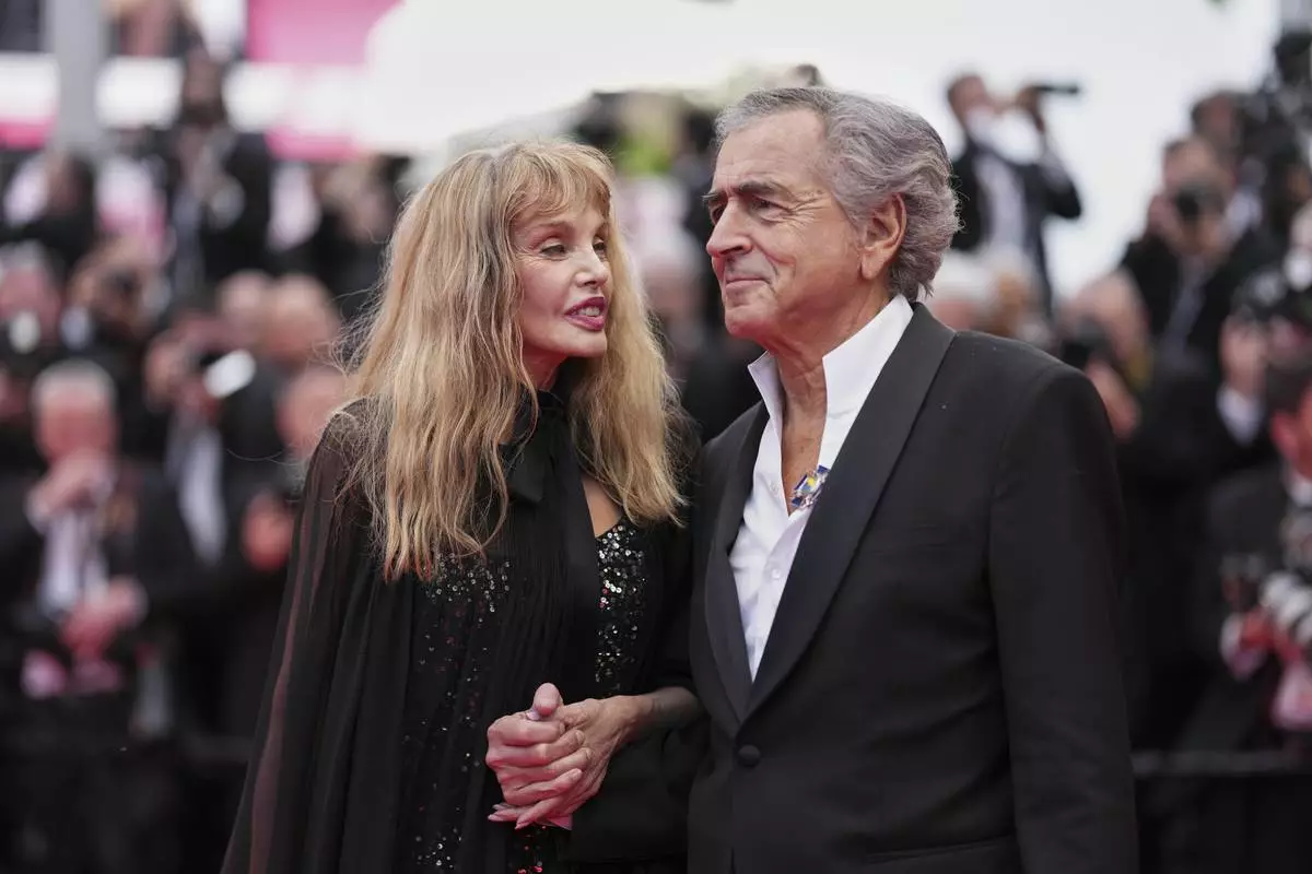 Arielle Dombasle, left, and Bernard-Henri Levy pose for photographers during the opening ceremony red carpet of the 78th international film festival, Cannes, southern France, Tuesday, May 13, 2025. (Photo by Scott A Garfitt/Invision/AP)