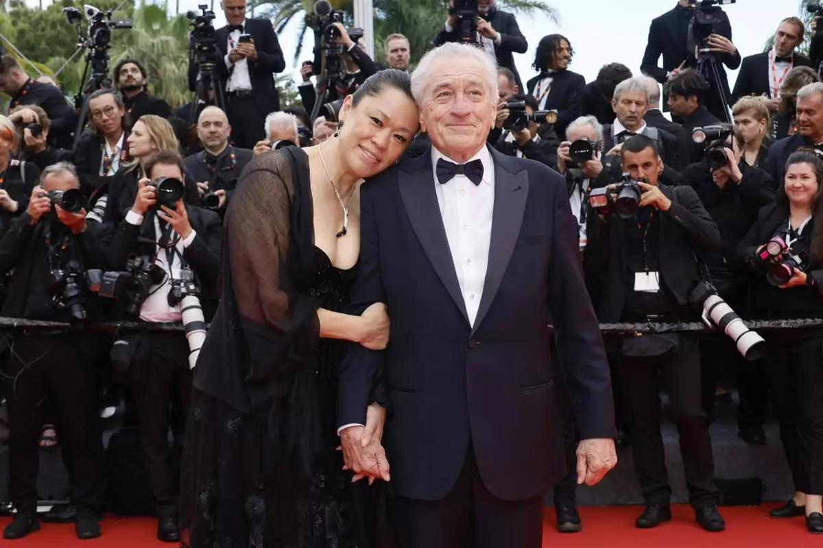 Tiffany Chen, left, and Robert De Niro pose for photographers during the opening ceremony red carpet of the 78th international film festival, Cannes, southern France, Tuesday, May 13, 2025. (Photo by Joel C Ryan/Invision/AP)