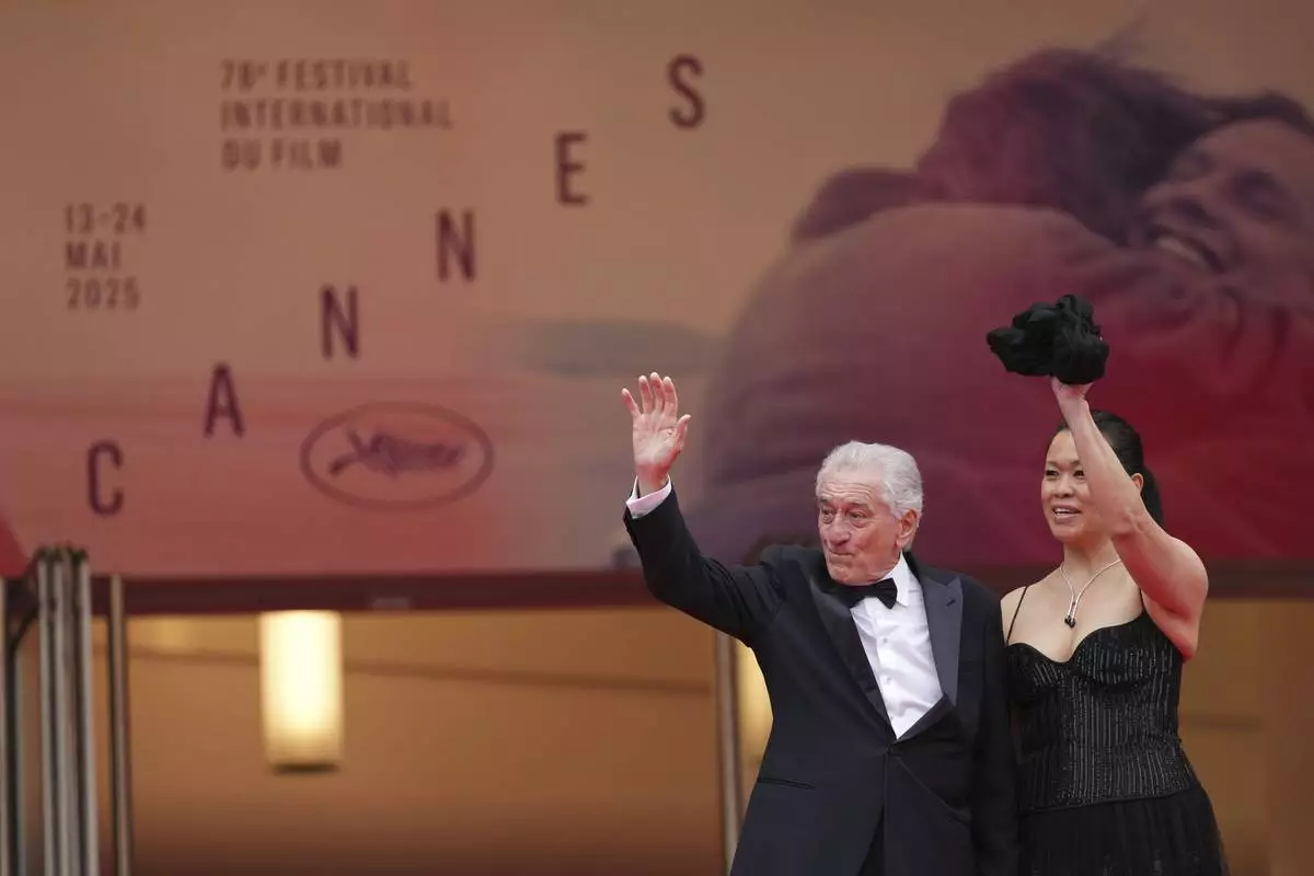 Robert De Niro, left, and Tiffany Chen pose for photographers during the opening ceremony red carpet of the 78th international film festival, Cannes, southern France, Tuesday, May 13, 2025. (Photo by Scott A Garfitt/Invision/AP)