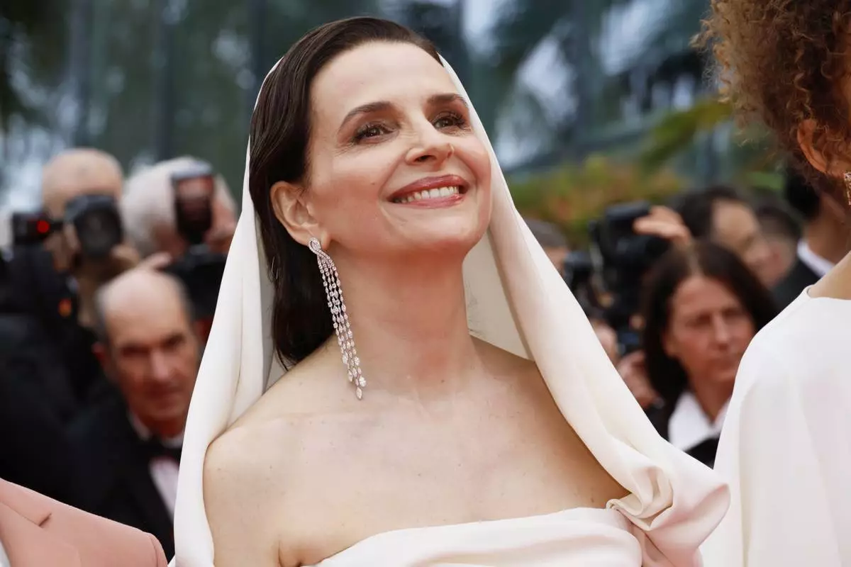 Jury president Juliette Binoche poses for photographers during the opening ceremony red carpet of the 78th international film festival, Cannes, southern France, Tuesday, May 13, 2025. (Photo by Joel C Ryan/Invision/AP)