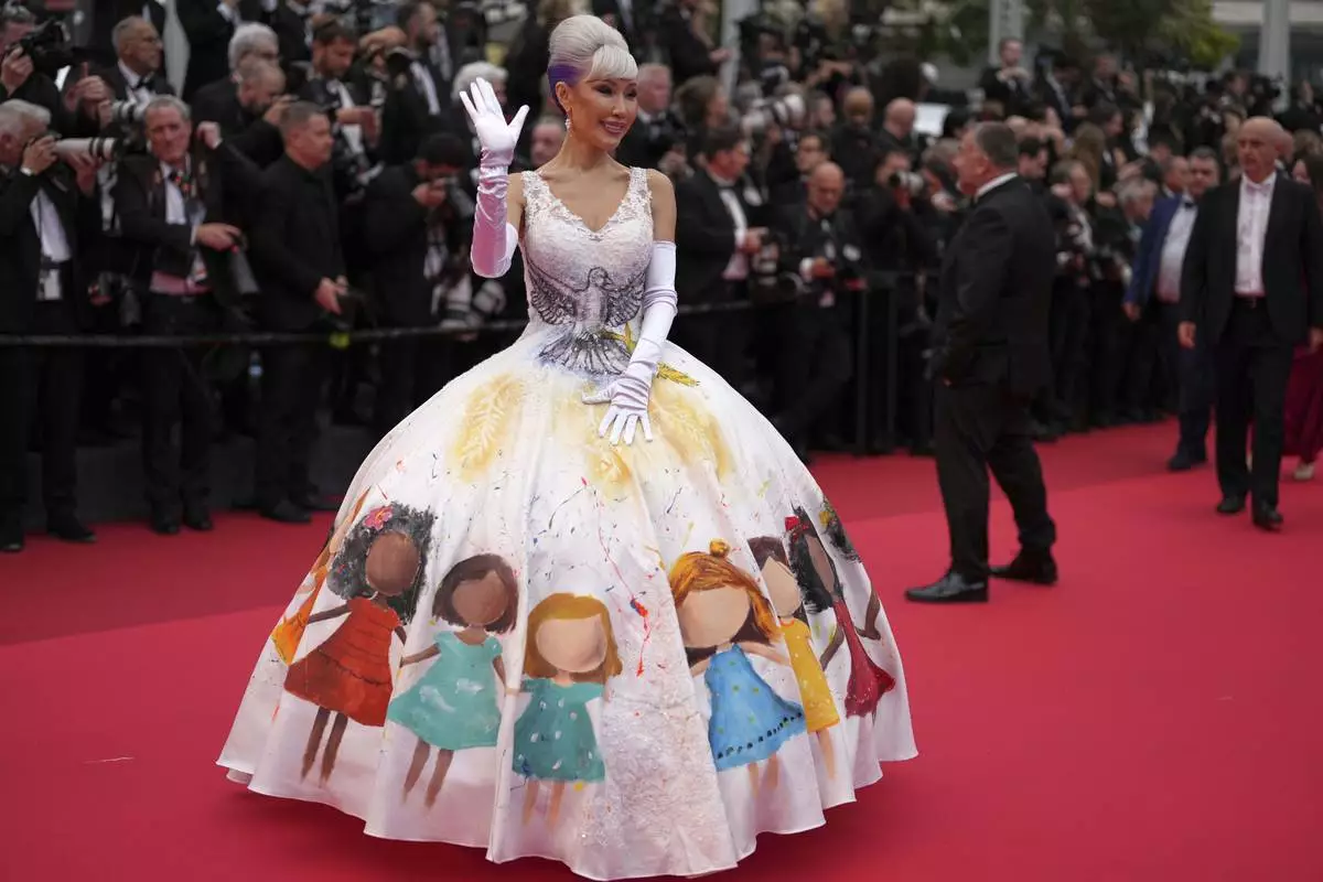 Aliia Roza poses for photographers during the opening ceremony red carpet of the 78th international film festival, Cannes, southern France, Tuesday, May 13, 2025. (AP Photo/Natacha Pisarenko)
