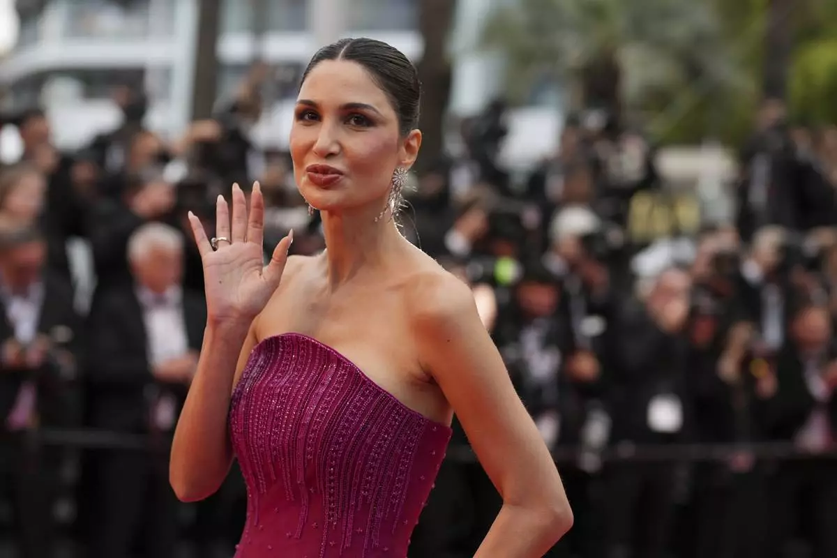Alice Abdel Aziz poses for photographers during the opening ceremony red carpet of the 78th international film festival, Cannes, southern France, Tuesday, May 13, 2025. (AP Photo/Natacha Pisarenko)