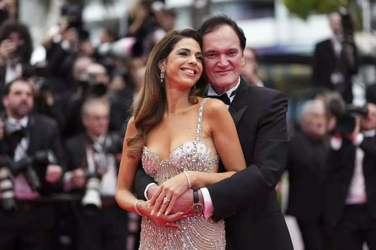Daniella Pick, left, and Quentin Tarantino pose for photographers during the opening ceremony red carpet of the 78th international film festival, Cannes, southern France, Tuesday, May 13, 2025. (Photo by Scott A Garfitt/Invision/AP)