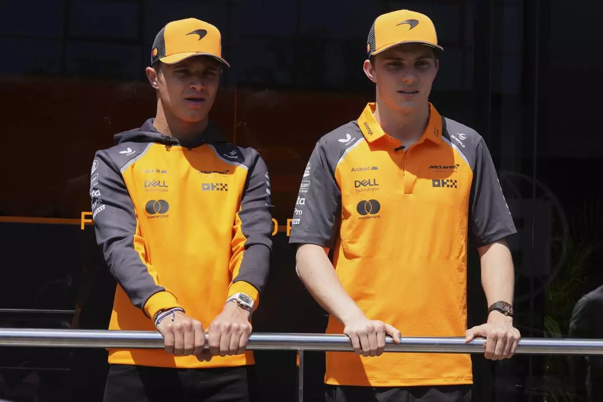 McLaren driver Lando Norris of Britain. left and McLaren driver Oscar Piastri of Australia talk to media before the first free practice at the Enzo and Dino Ferrari racetrack, ahead the Italy's Emilia Romagna Formula One Grand Prix, in Imola, Italy, Friday, May 16, 2025. (AP Photo/Antonio Calanni)