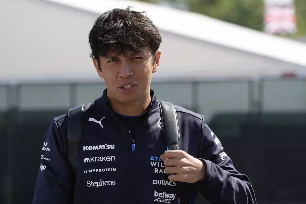 Williams driver Alexander Albon of Thailand arrives prior to the first free practice at the Enzo and Dino Ferrari racetrack, ahead the Italy's Emilia Romagna Formula One Grand Prix, in Imola, Italy, Friday, May 16, 2025. (AP Photo/Luca Bruno)