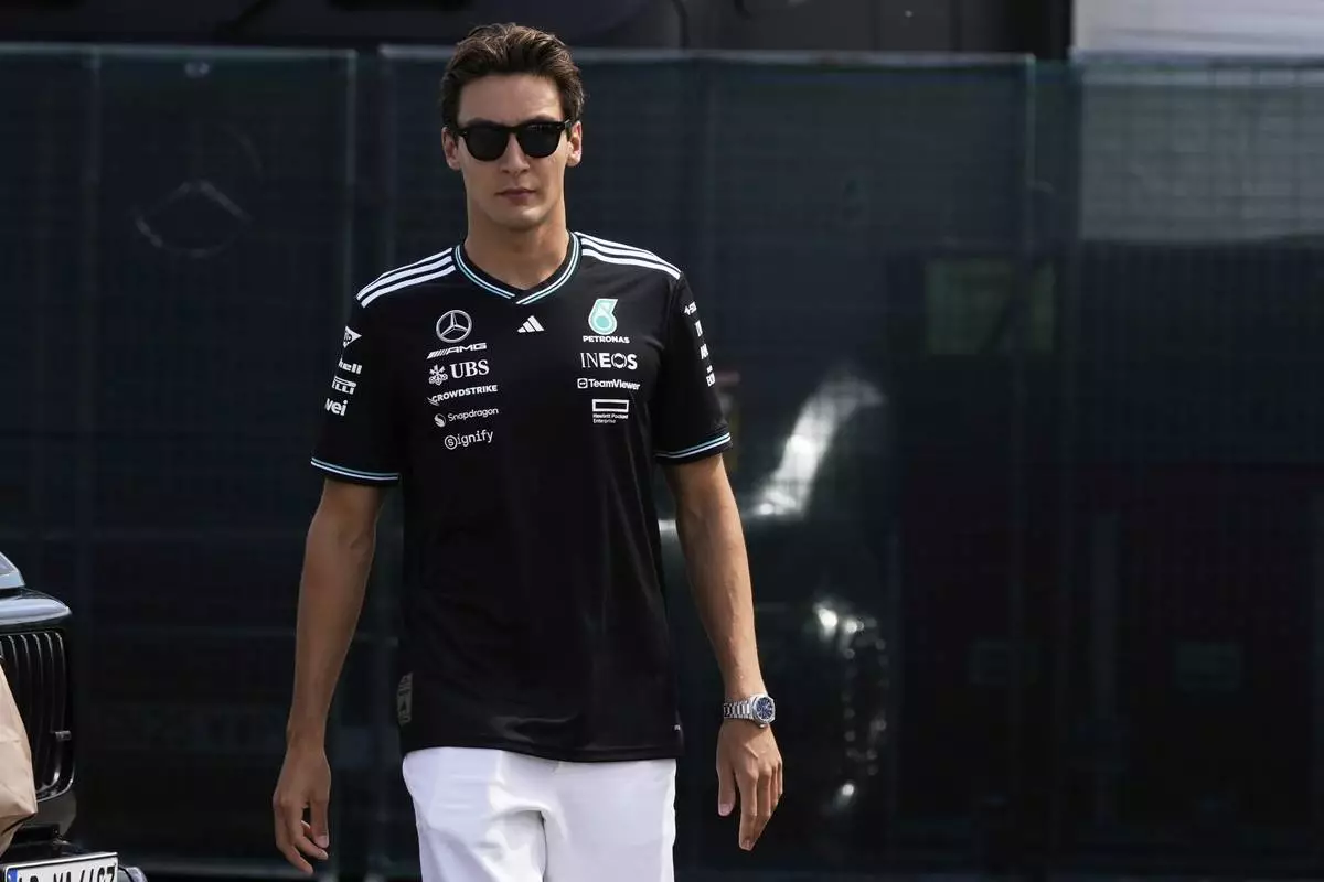 Mercedes driver George Russell of Britain arrives prior to the first free practice at the Enzo and Dino Ferrari racetrack, ahead the Italy's Emilia Romagna Formula One Grand Prix, in Imola, Italy, Friday, May 16, 2025. (AP Photo/Luca Bruno)