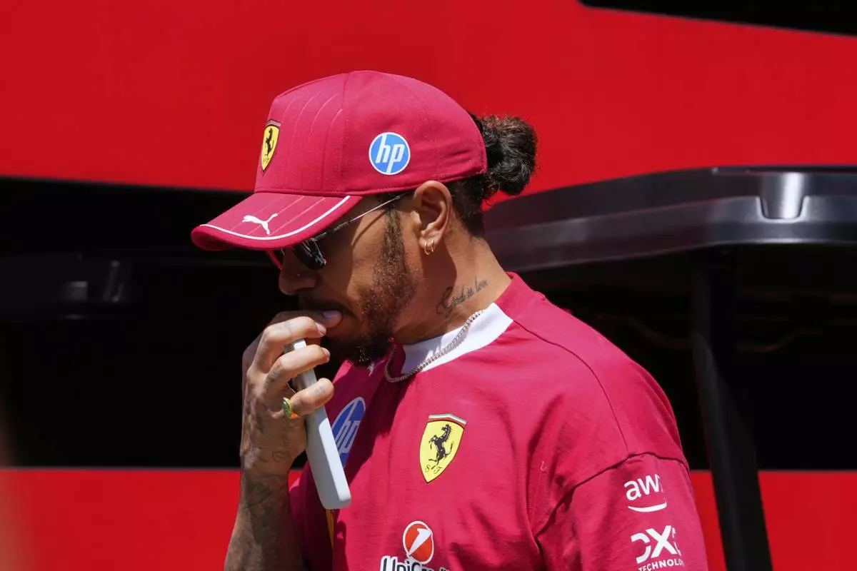 Ferrari driver Lewis Hamilton of Britain arrives prior to the first free practice at the Enzo and Dino Ferrari racetrack, ahead the Italy's Emilia Romagna Formula One Grand Prix, in Imola, Italy, Friday, May 16, 2025. (AP Photo/Luca Bruno)