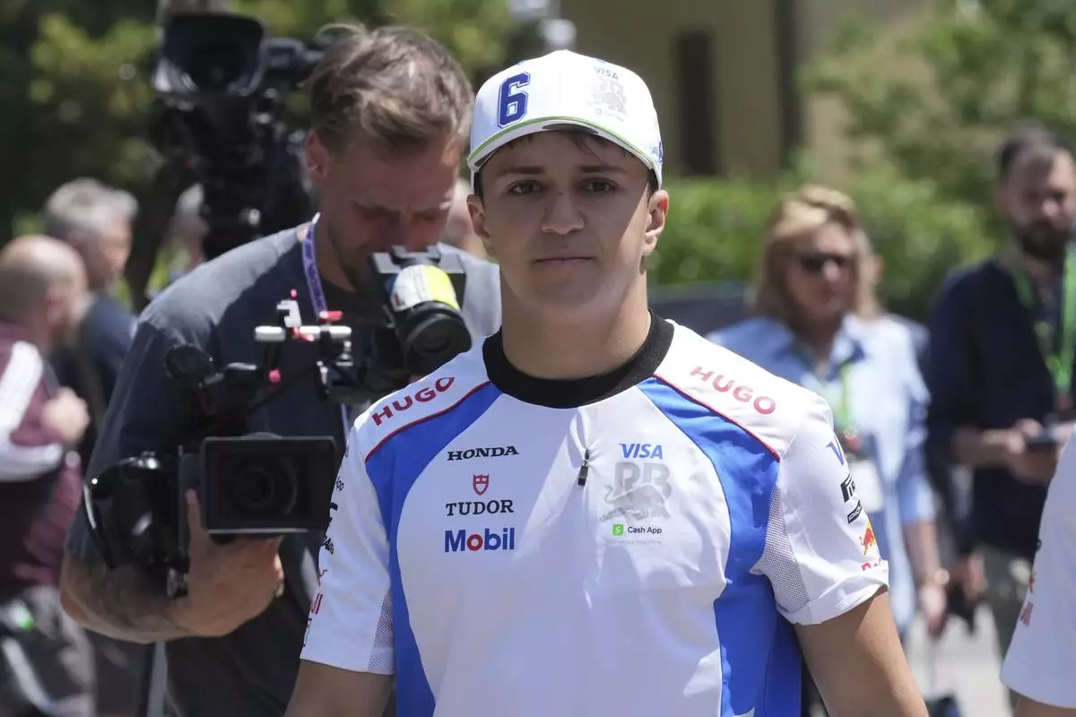 Racing Bulls driver Isack Hadjar of France arrives at the Dino and Enzo Ferrari racetrack, ahead the Italy's Emilia Romagna Formula One Grand Prix in Imola, Italy, Thursday, May 15, 2025. (AP Photo/Antonio Calanni)