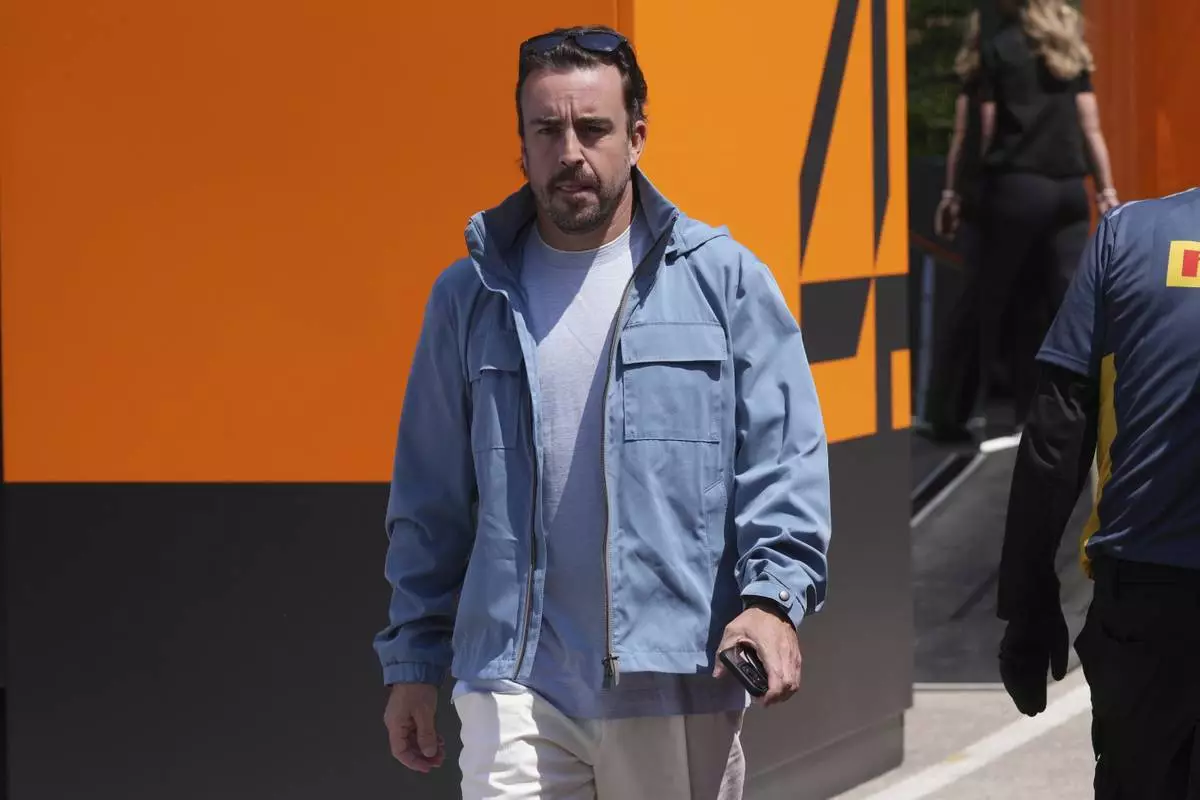 Aston Martin driver Fernando Alonso of Spain arrives at the Dino and Enzo Ferrari racetrack, ahead the Italy's Emilia Romagna Formula One Grand Prix in Imola, Italy, Thursday, May 15, 2025. (AP Photo/Antonio Calanni)