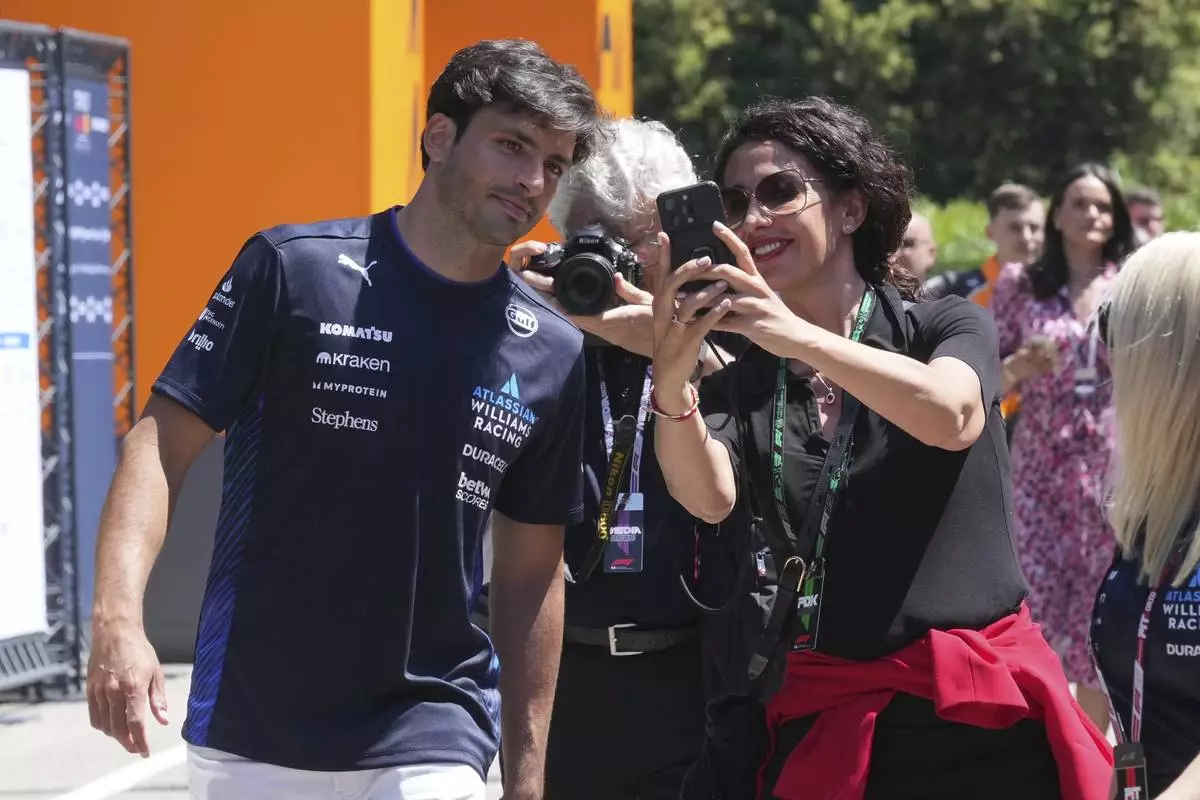 Williams driver Carlos Sainz of Spain, left, arrives at the Dino and Enzo Ferrari racetrack, in Imola, Italy, Thursday, May 15, 2025. (AP Photo/Antonio Calanni)