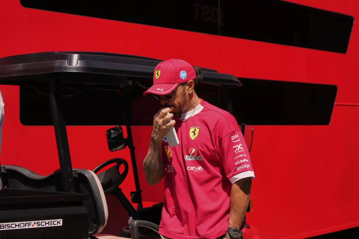 Ferrari driver Lewis Hamilton of Britain arrives prior to the first free practice at the Enzo and Dino Ferrari racetrack, ahead the Italy's Emilia Romagna Formula One Grand Prix, in Imola, Italy, Friday, May 16, 2025. (AP Photo/Luca Bruno)