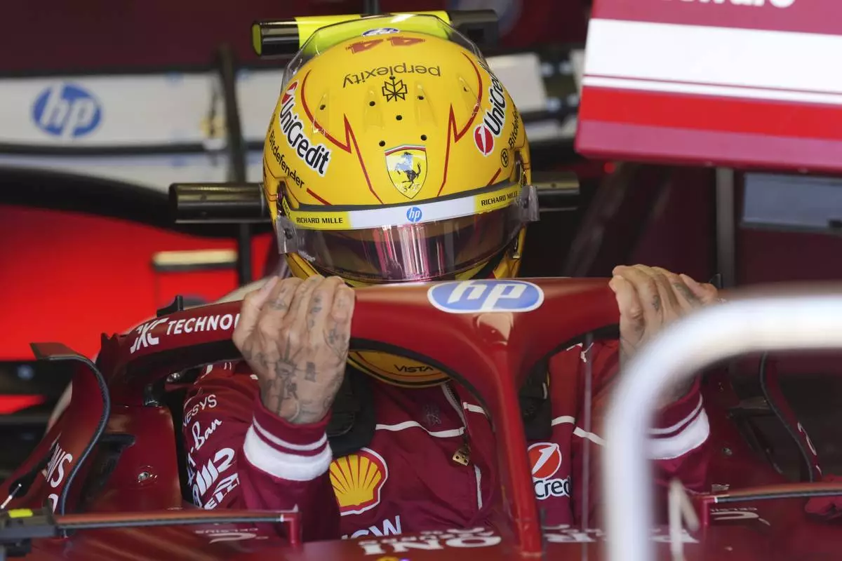 Ferrari driver Lewis Hamilton of Britain gets ready during the first free practice at the Enzo and Dino Ferrari racetrack, ahead the Italy's Emilia Romagna Formula One Grand Prix, in Imola, Italy, Friday, May 16, 2025. (AP Photo/Antonio Calanni)