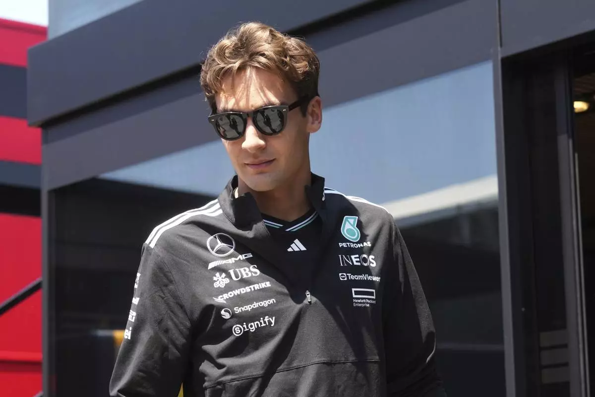 Mercedes driver George Russell of Britain arrives at the Dino and Enzo Ferrari racetrack, in Imola, Italy, Thursday, May 15, 2025. (AP Photo/Antonio Calanni)