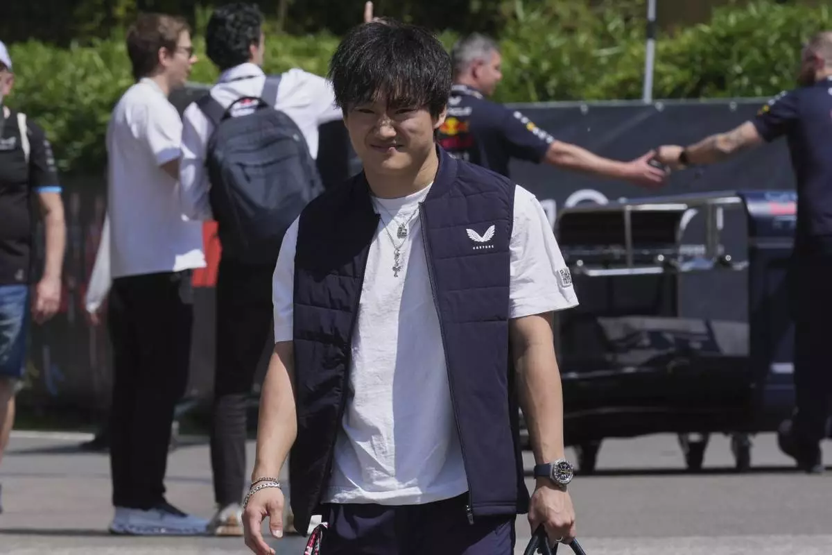 Red Bull driver Yuki Tsunoda of Japan arrives for the first free practice at the Enzo and Dino Ferrari racetrack, ahead the Italy's Emilia Romagna Formula One Grand Prix, in Imola, Italy, Friday, May 16, 2025. (AP Photo/Antonio Calanni)