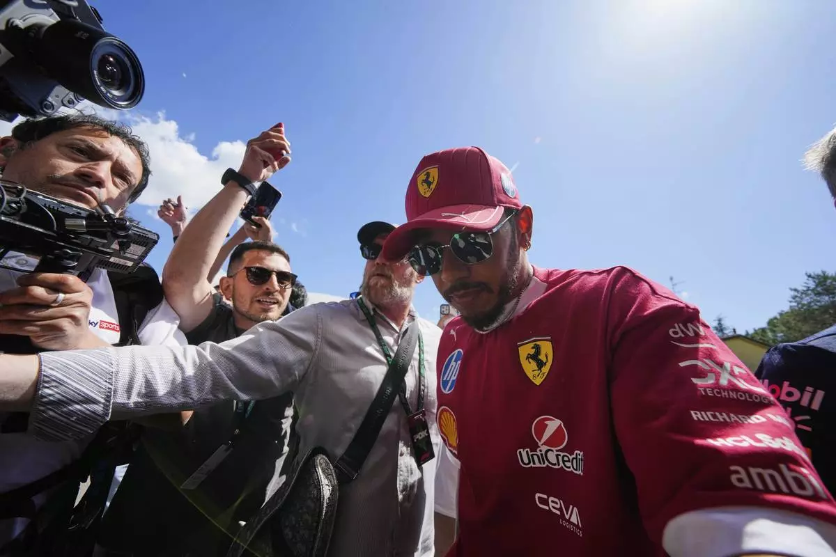 Ferrari driver Lewis Hamilton of Britain arrives prior to the first free practice at the Enzo and Dino Ferrari racetrack, ahead the Italy's Emilia Romagna Formula One Grand Prix, in Imola, Italy, Friday, May 16, 2025. (AP Photo/Luca Bruno)