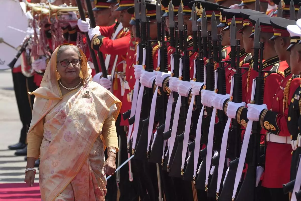 FILE - Bangladesh's Prime Minister Sheikh Hasina reviews an honor guard during a welcome ceremony at the government house in Bangkok, Thailand, Friday, April 26, 2024. (AP Photo/Sakchai Lalit, File)