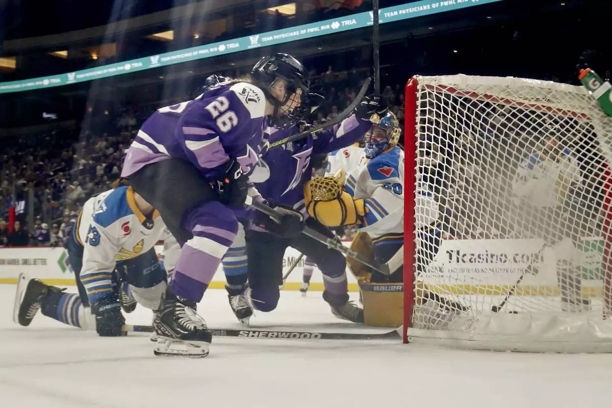 CORRECTS TO GOAL BY FROST'S SOPHIE JAQUES NOT KENDALL COYNE SCHOFIELD - Minnesota Frost forward Kendall Coyne Schofield (26) celebrates after a goal by teammate Sophie Jaques (not shown) against Toronto Sceptres goaltender Kristen Campbell, fourth from left, in the second period of a PWHL hockey playoff game Sunday, May 11, 2025, in St. Paul, Minn. (AP Photo/Bruce Kluckhohn)