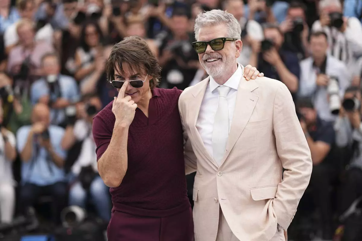 Tom Cruise, left, and director Christopher McQuarrie pose for photographers during the photo call for the film 'Mission: Impossible – The Final Reckoning' at the 78th international film festival, Cannes, southern France, Wednesday, May 14, 2025. (Photo by Scott A Garfitt/Invision/AP)
