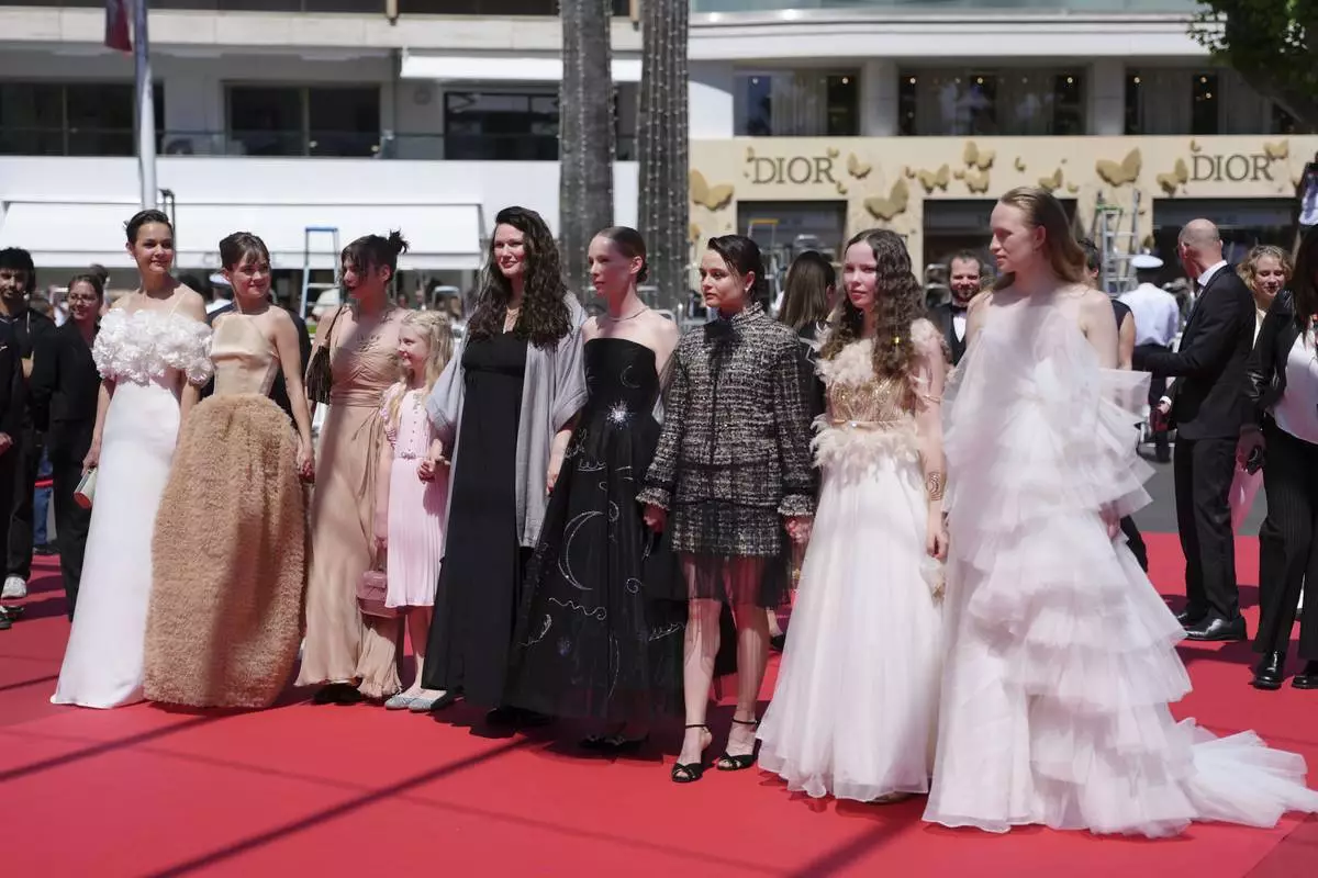 Luise Heyer, from left, Lea Drinda, producer Maren Schmitt, Hanna Heckt, director Mascha Schilinski, Susanne Wust, Lena Urzendowsky, Laeni Geiseler and Luzia Oppermann pose for photographers upon arrival at the premiere of the film 'Sound of Falling' at the 78th international film festival, Cannes, southern France, Wednesday, May 14, 2025. (Photo by Lewis Joly/Invision/AP)