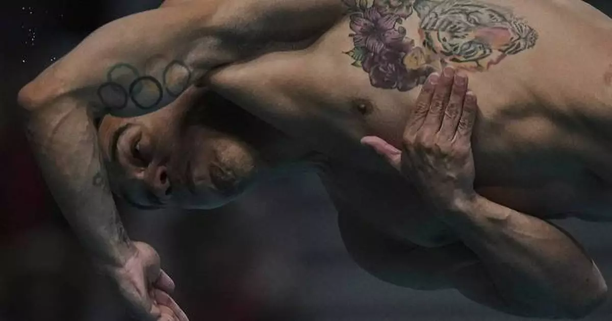AP PHOTOS: Expressions of divers in the split second between diving board and the water