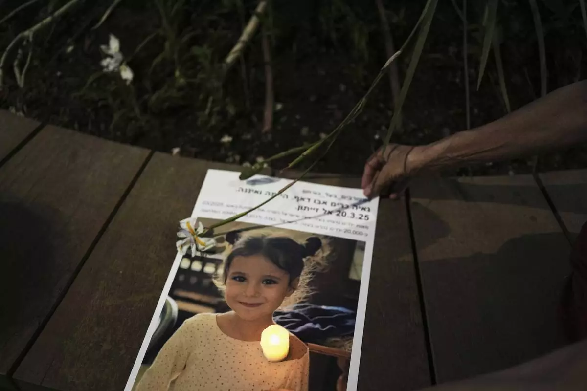 A photo of 5-year-old Palestinian girl Naya Kareem, who was killed during the Israel-Hamas war in Gaza, is displayed during a protest calling for an end to the war, in Tel Aviv, Israel, on Saturday, May 17, 2025. (AP Photo/Maya Alleruzzo)