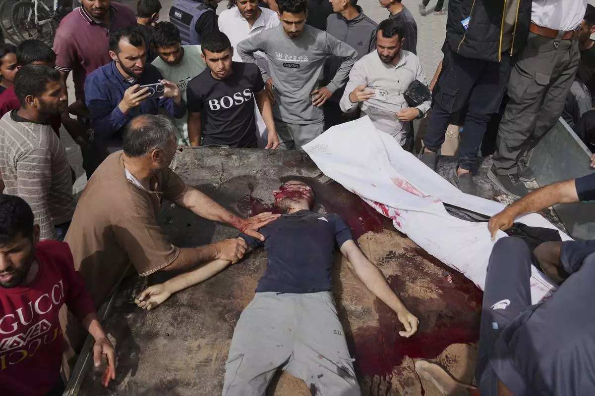 EDS NOTE: GRAPHIC CONTENT - Palestinians killed in an Israeli airstrike on central Gaza Strip are brought to Al-Aqsa Hospital in Deir al-Balah, on Saturday, May 17, 2025. (AP Photo/Abdel Kareem Hana)