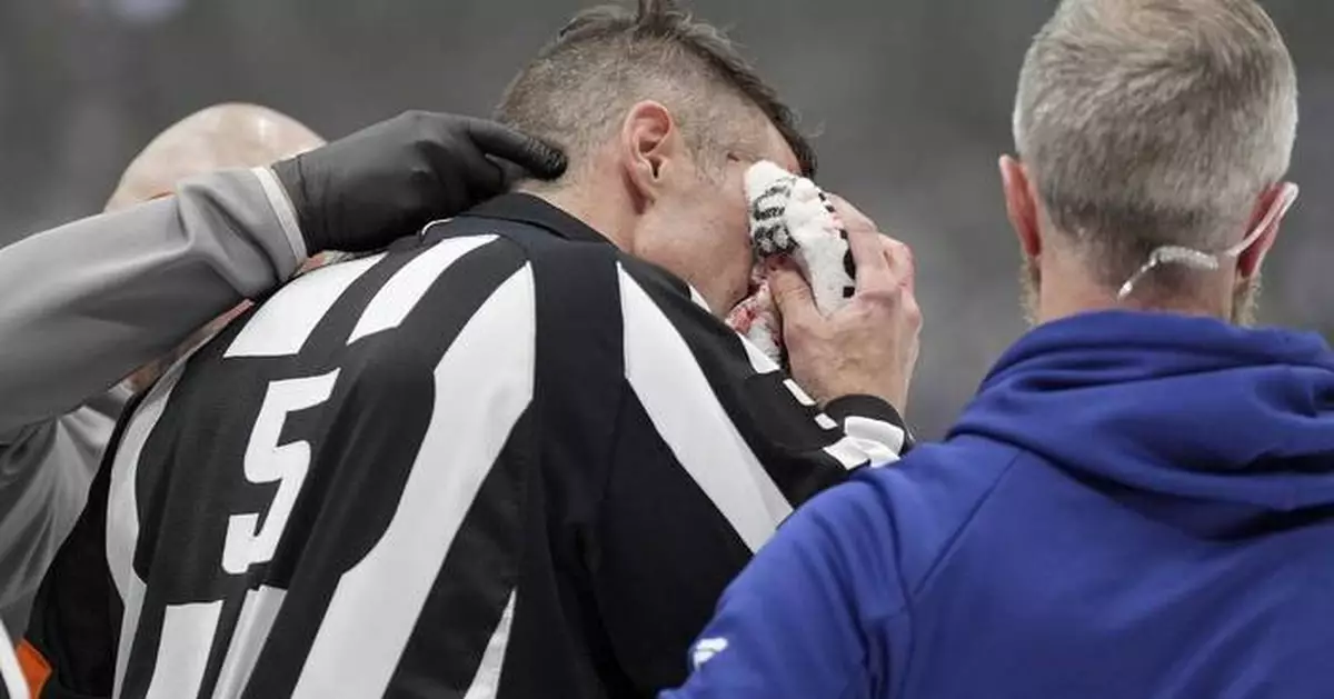 Referee Chris Rooney forced out of Game 7 after taking stick to face