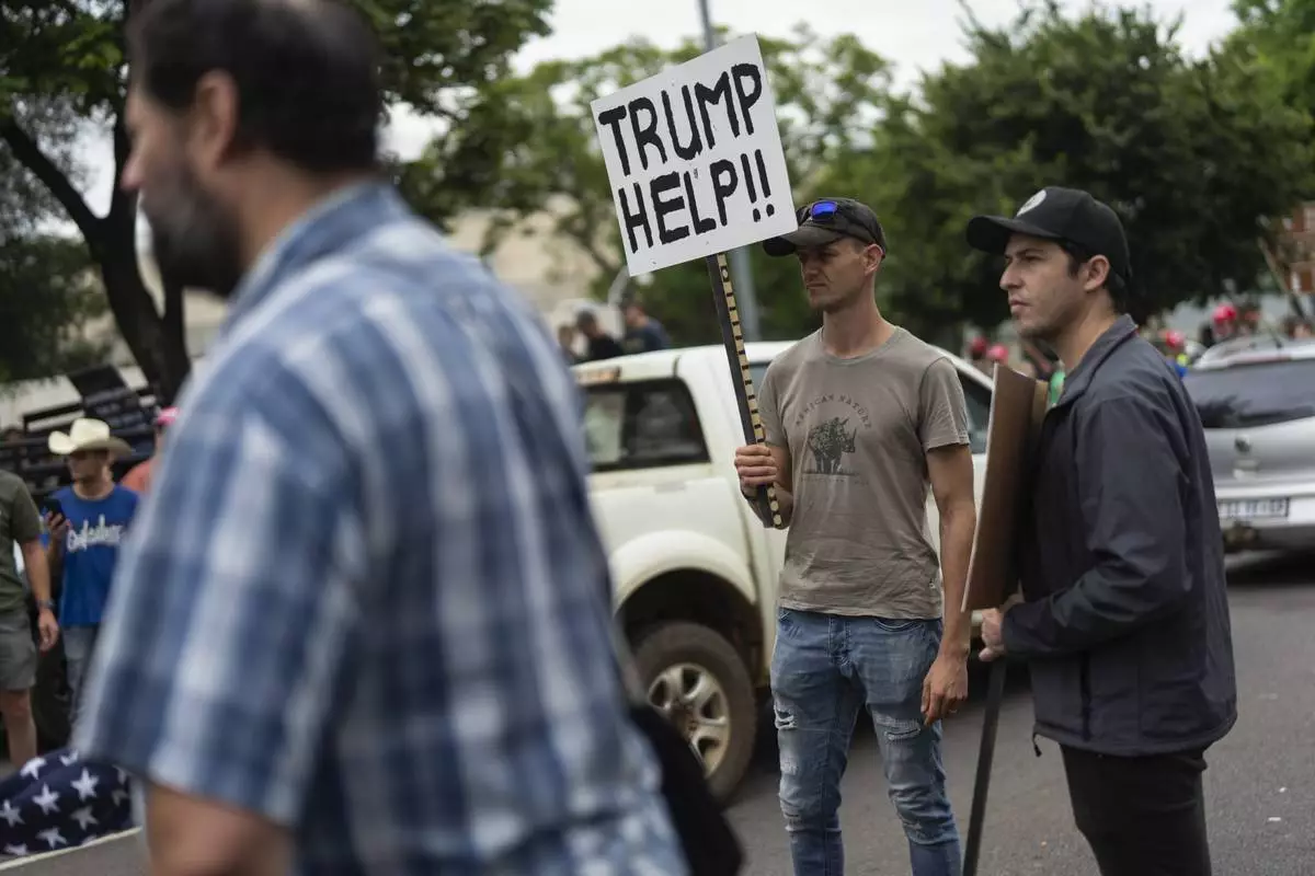 FILE - White South Africans demonstrate in support of U.S. President Donald Trump in front of the U.S. embassy in Pretoria, South Africa, Saturday, Feb. 15, 2025. (AP Photo/Jerome Delay, File)