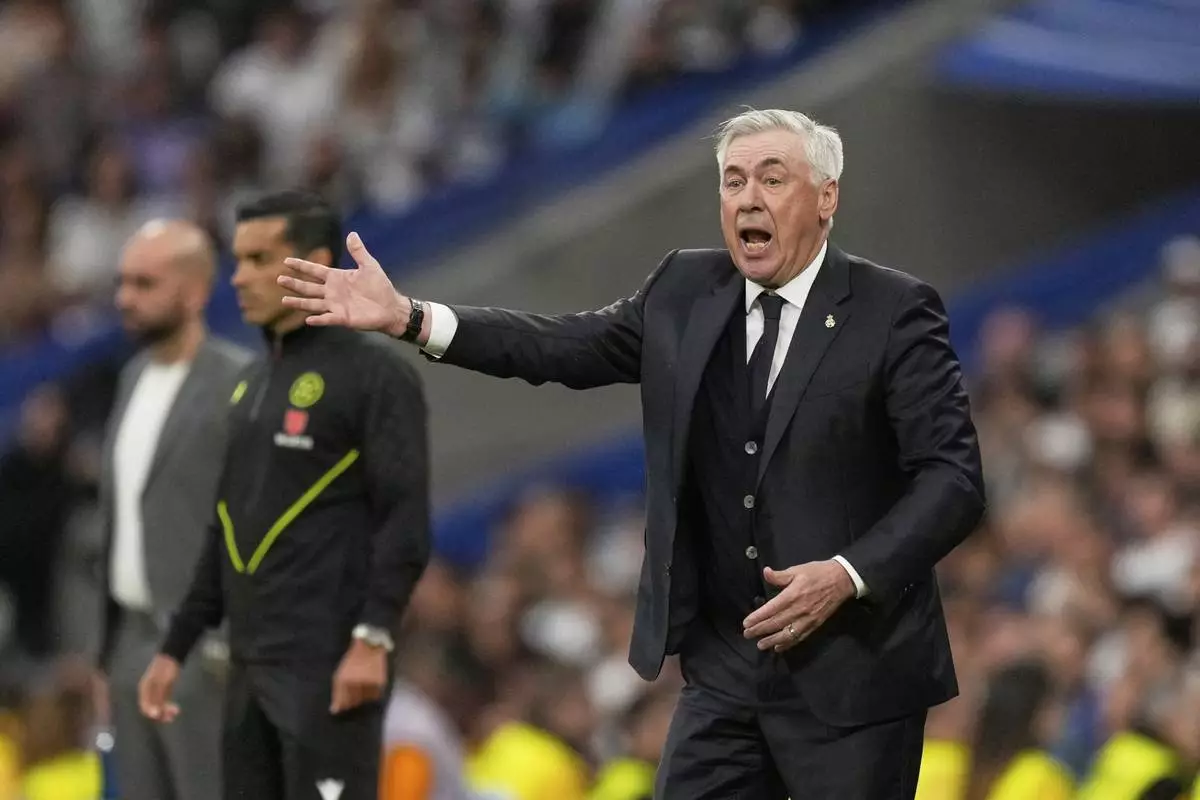 Real Madrid's head coach Carlo Ancelotti reacts during the Spanish La Liga soccer match between Real Madrid and Celta Vigo at the Santiago Bernabeu stadium in Madrid, Spain, Sunday, May 4, 2025. (AP Photo/Jose Breton)