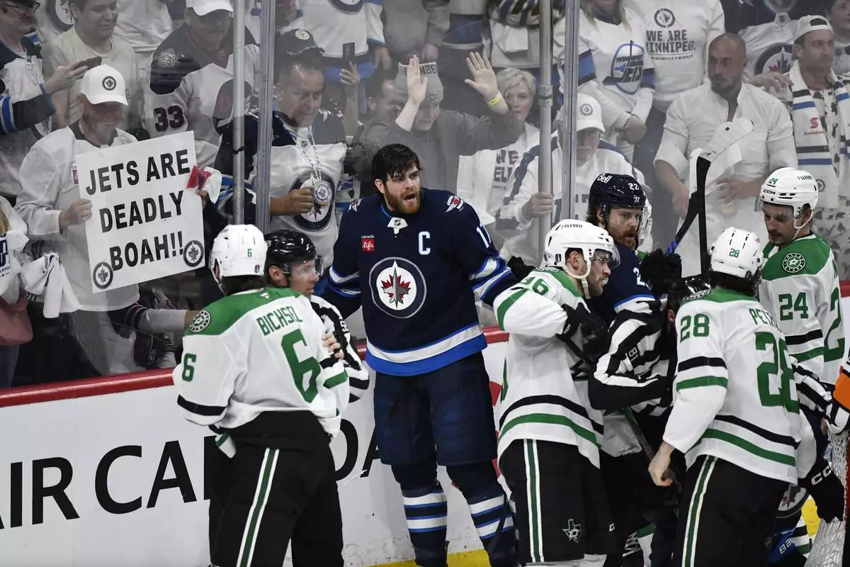 Winnipeg Jets' Adam Lowry (17) and Dallas Stars players push and shove at the end of a play during third period NHL playoff hockey action in Winnipeg, Thursday, May 15, 2025. (Fred Greenslade/The Canadian Press via AP)