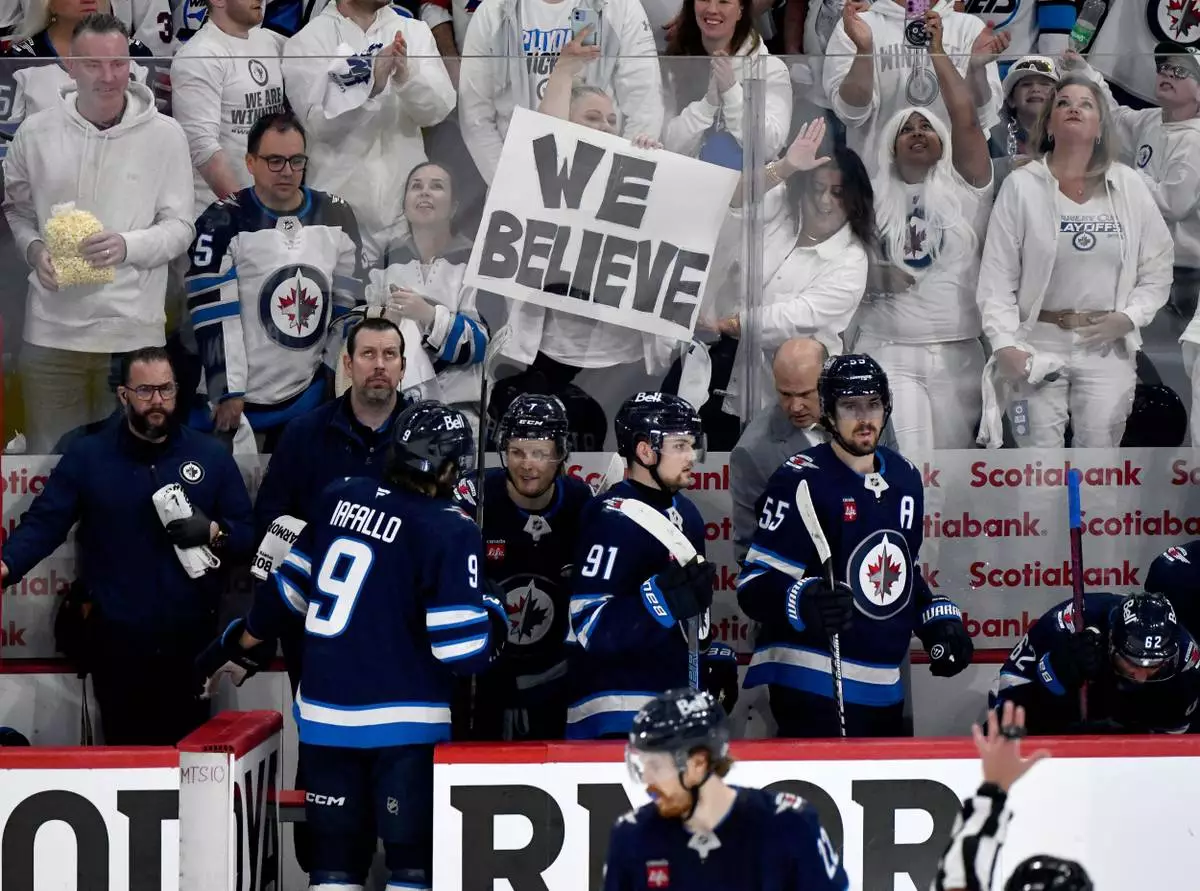Winnipeg Jets' Vladislav Namestnikov (7) returns to the bench with teammates after scoring on the Dallas Stars during the third period of an NHL playoff hockey game in Winnipeg, Thursday, May 15, 2025. (Fred Greenslade/The Canadian Press via AP)