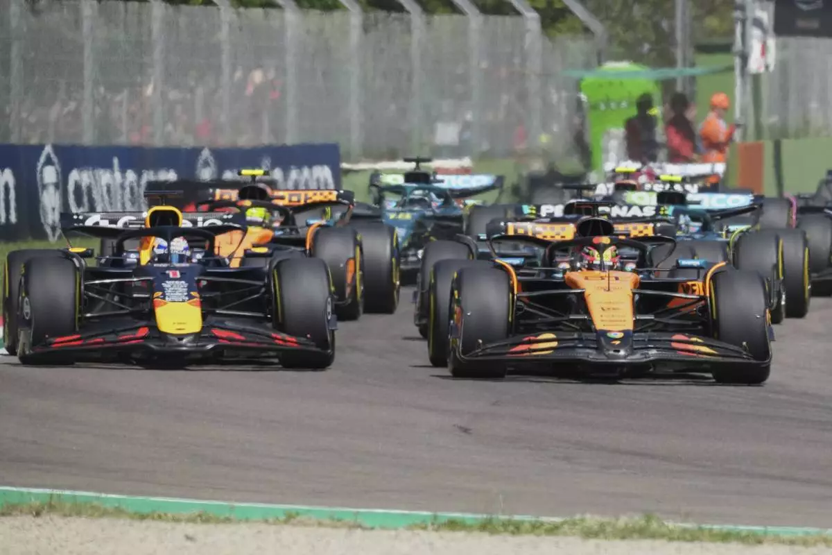 Red Bull driver Max Verstappen of the Netherlands, left, and McLaren driver Oscar Piastri of Australia leadat the start during the Italy's Emilia Romagna Formula One Grand Prix, in Imola, Italy, Sunday, May 18, 2025. (AP Photo/Antonio Calanni)
