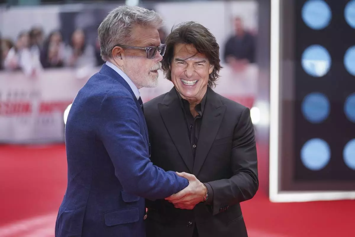 Director Christopher McQuarrie, left, and Tom Cruise pose for photographers upon arrival at the premiere of the film 'Mission: Impossible - The Final Reckoning' on Thursday, May 15, 2025, in London. (Photo by Alberto Pezzali/Invision/AP)
