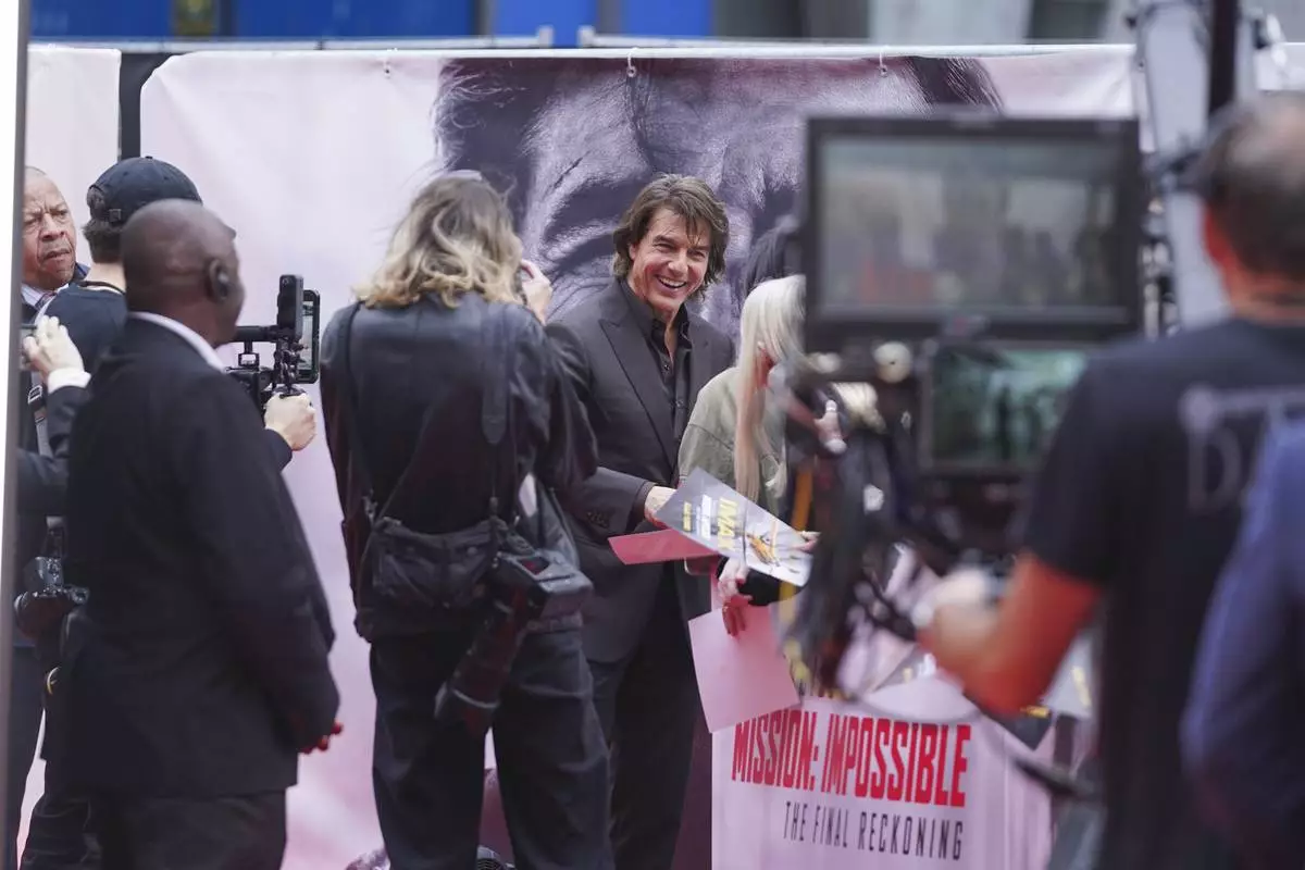 Tom Cruise poses for photographers upon arrival at the premiere of the film 'Mission: Impossible - The Final Reckoning' on Thursday, May 15, 2025, in London. (Photo by Alberto Pezzali/Invision/AP)