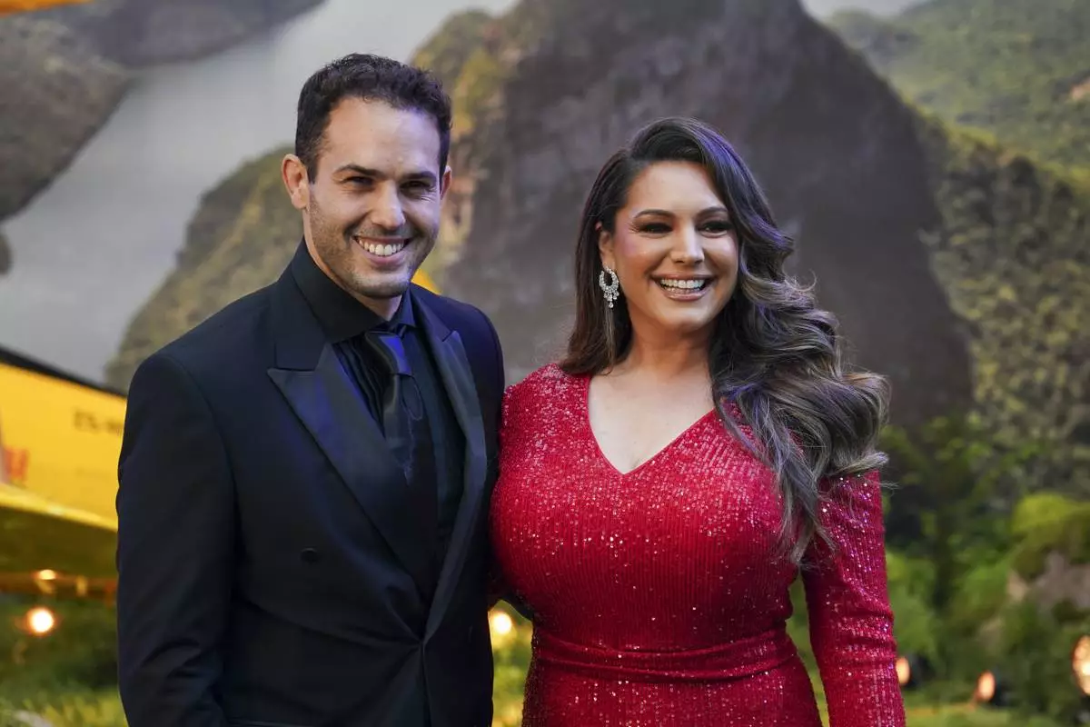 Jeremy Parisi, left, and Kelly Brook pose for photographers upon arrival at the premiere of the film 'Mission: Impossible - The Final Reckoning' on Thursday, May 15, 2025, in London. (Photo by Alberto Pezzali/Invision/AP)