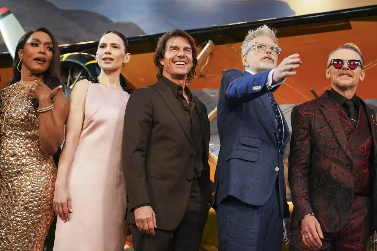 Angela Bassett, from left, Hayley Atwell, Tom Cruise, director Christopher McQuarrie, and Simon Pegg pose for photographers upon arrival at the premiere of the film 'Mission: Impossible - The Final Reckoning' on Thursday, May 15, 2025, in London. (Photo by Alberto Pezzali/Invision/AP)