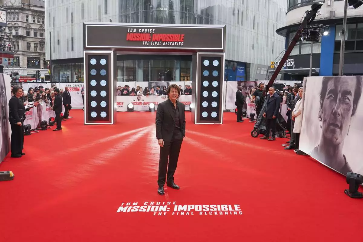 Tom Cruise poses for photographers upon arrival at the premiere of the film 'Mission: Impossible - The Final Reckoning' on Thursday, May 15, 2025, in London. (Photo by Alberto Pezzali/Invision/AP)