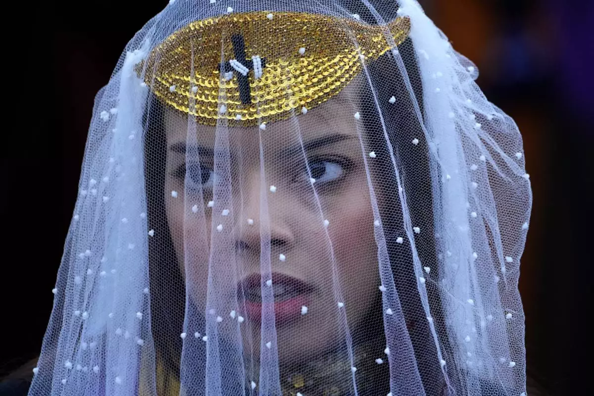 An Order of the Sunrise follower attends an annual ceremony known as the "Day of the Spiritual Indoctrinator," at the group's lakeside temple in Planaltina, Brazil, Thursday, May 1, 2025. (AP Photo/Eraldo Peres)