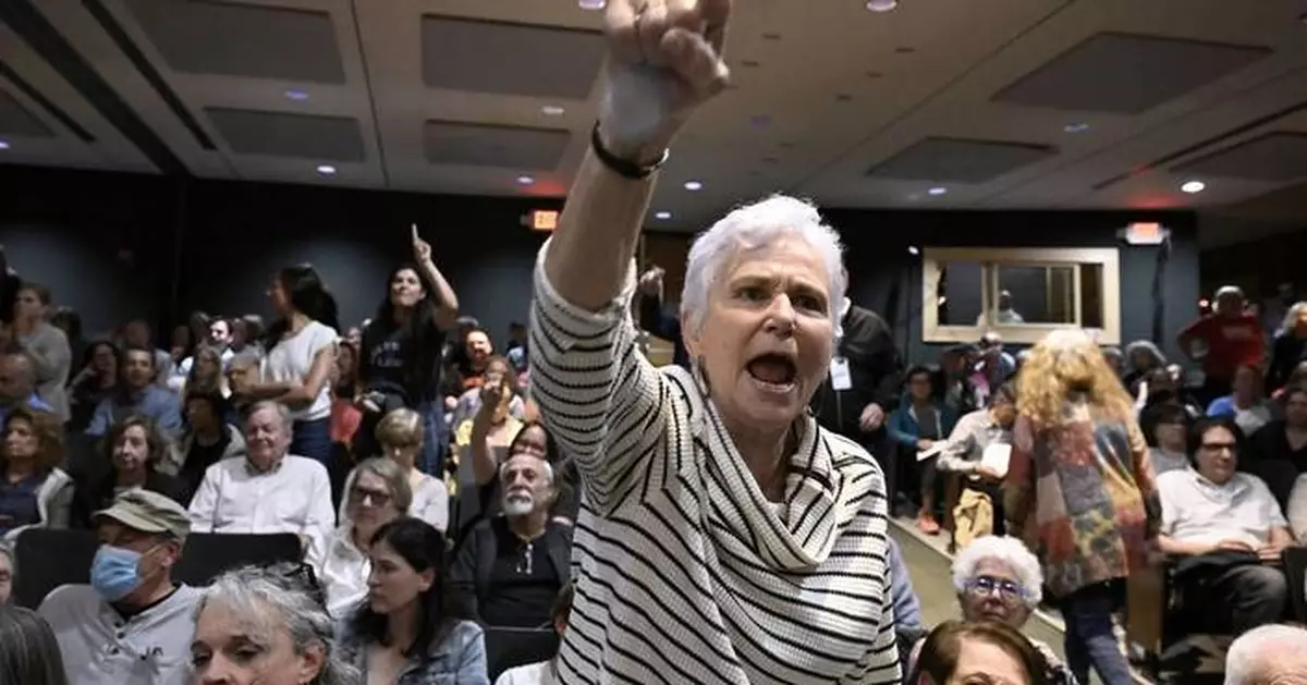 A GOP congressman is peppered with questions about Trump during raucous town hall