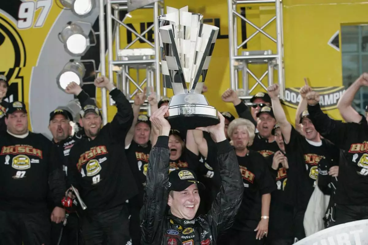 Nascar driver Kurt Busch raises the Nextel 2004 Cup Championship trophy Sunday Nov. 21, 2004 at the Homestead Miami Speedway in Homestead, Fla. (AP Photo/Terry Renna, File)