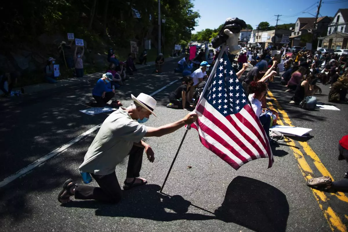 Demonstrators kneel during a solidarity protest for George Floyd, Saturday, June 13, 2020, in West Point, N.Y. (AP Photo/Eduardo Munoz Alvarez, File)