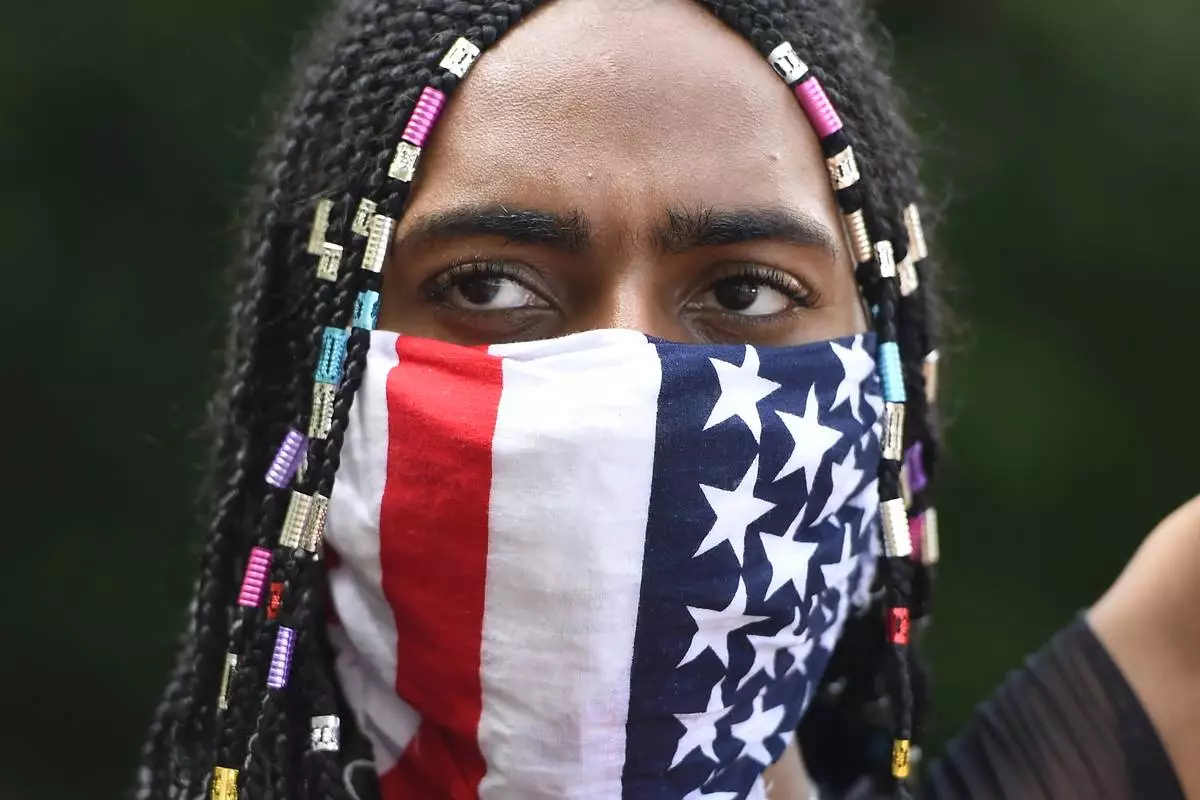 Demonstrators protest across the street from a Confederate memorabilia store in Kennesaw, Ga., on Friday, June 5, 2020, following the death of George Floyd. (AP Photo/Mike Stewart, File)