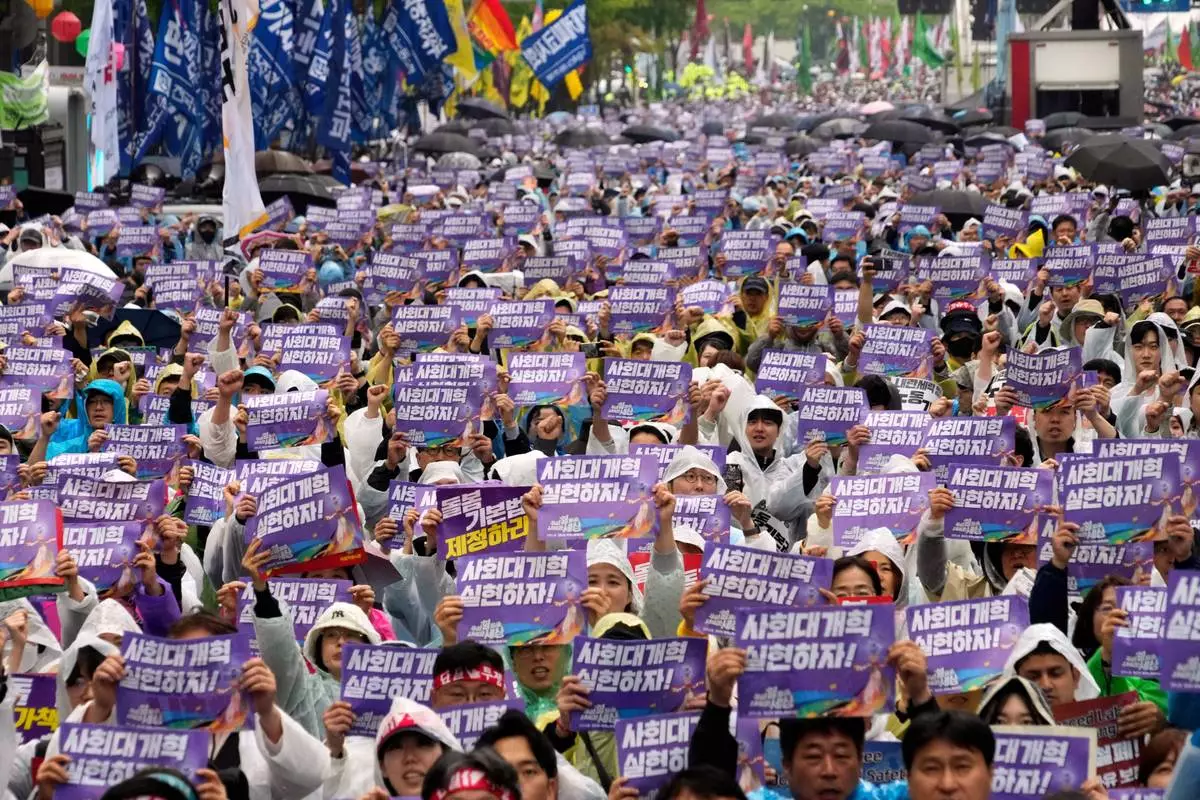 Members of the Korean Confederation of Trade Unions gather to attend a rally on May Day in Seoul, South Korea, Thursday, May 1, 2025. The letters read "Let's practice social reform." (AP Photo/Ahn Young-joon)