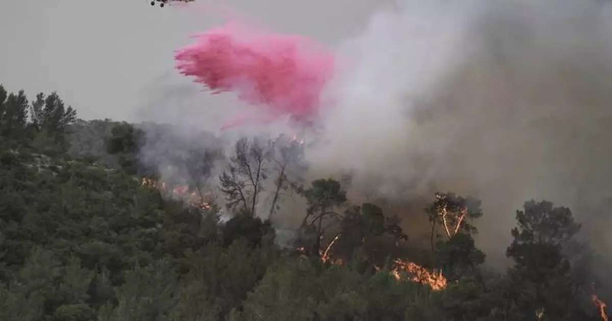 A wildfire closes main highway linking Tel Aviv to Jerusalem and sends 12 people to the hospital