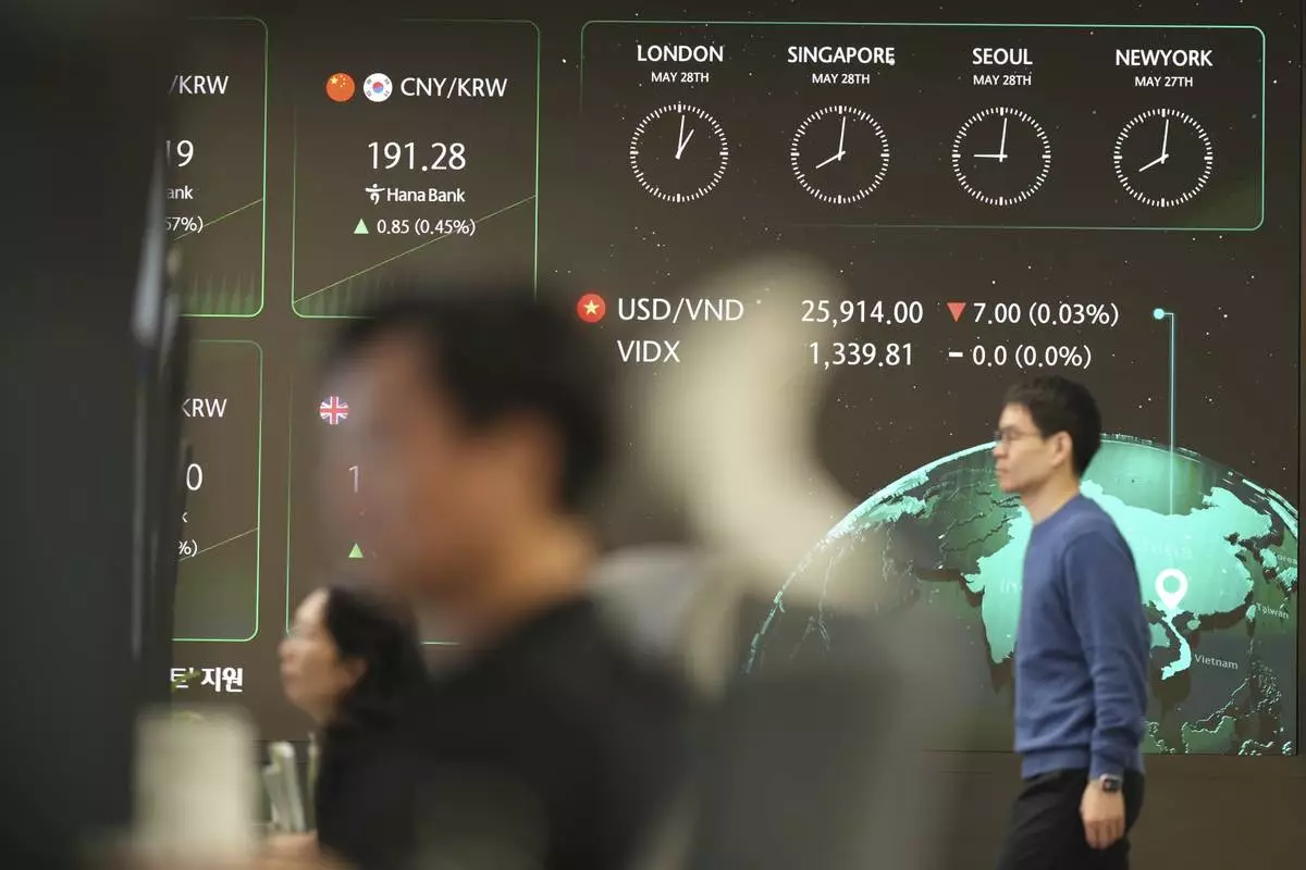 The screens show the foreign exchange rates are seen at a dealing room of Hana Bank in Seoul, South Korea, Wednesday, May 28, 2025. (AP Photo/Lee Jin-man)